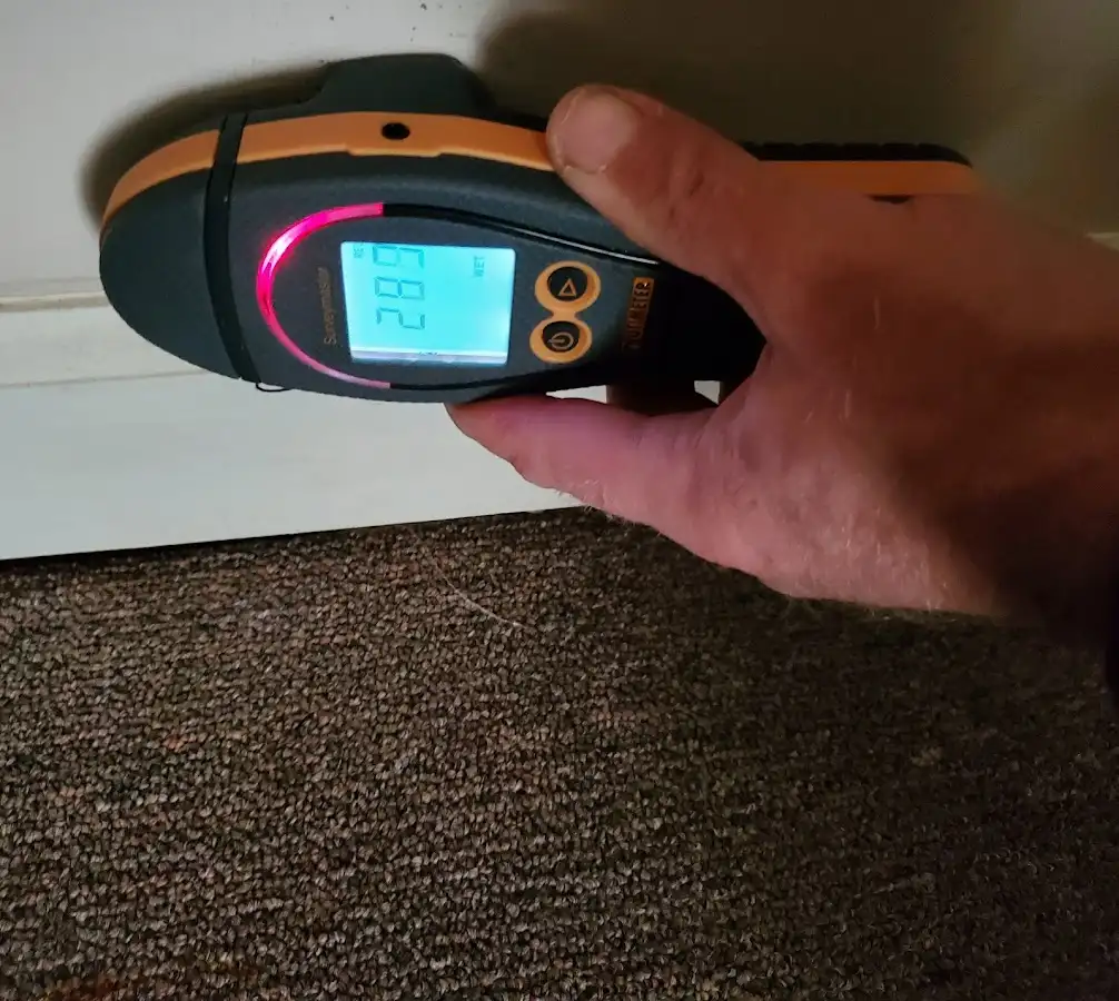 Moisture detection at baseboard during Storm Damage Restoration in Granby